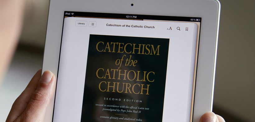 WOMAN DISPLAYS E-BOOK VERSION OF CATHOLIC CATECHISM