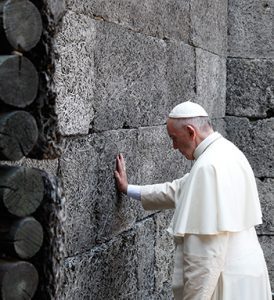 Pope Francis touches the death wall at the Auschwitz