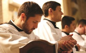 A seminarian prays during a Holy Hour for vocations (CNS photo/Gregory A. Shemitz, Long Island Catholic)