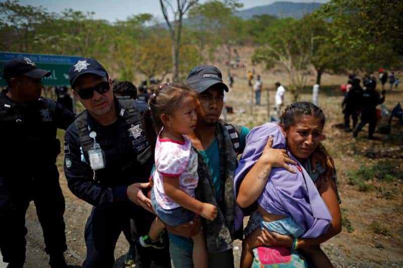 A family of Central American migrants is detained by Mexican federal police officers