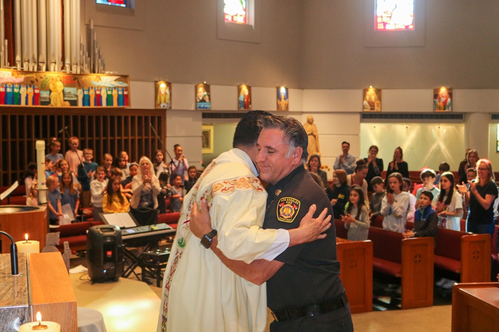 PASTOR EMBRACE LAFD CHIEF MASS GETTY FIRE