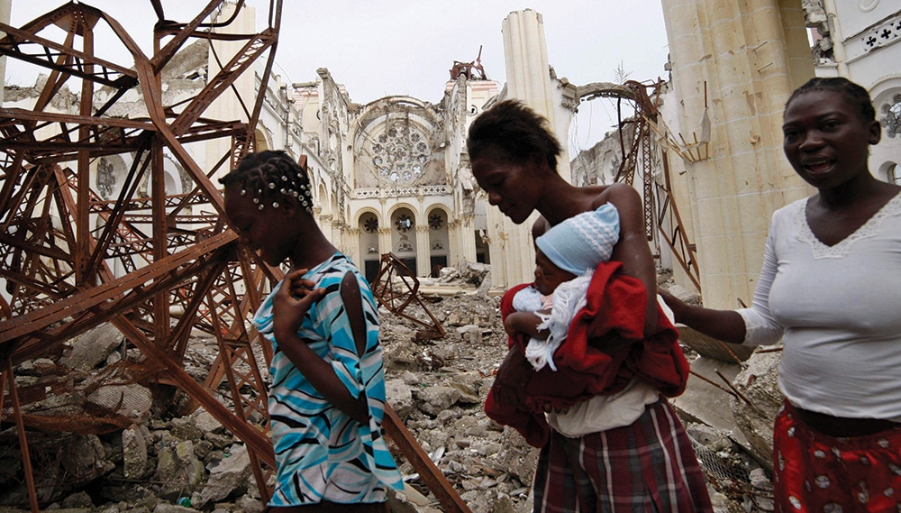 WOMEN PASS DESTROYED CATHEDRAL IN PORT-AU-PRINCE
