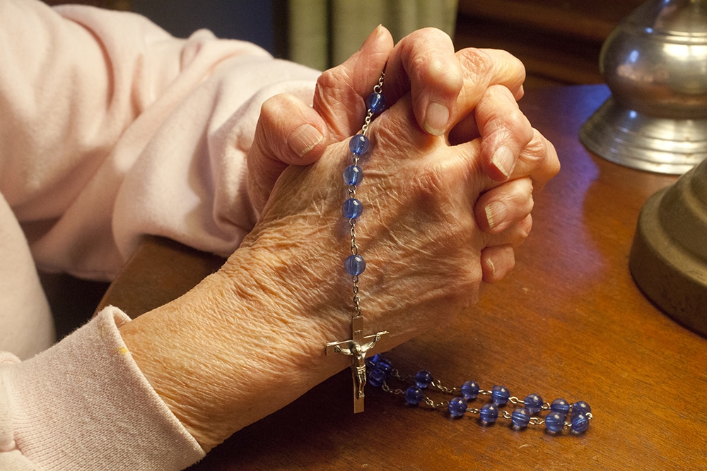 Elderly woman praying