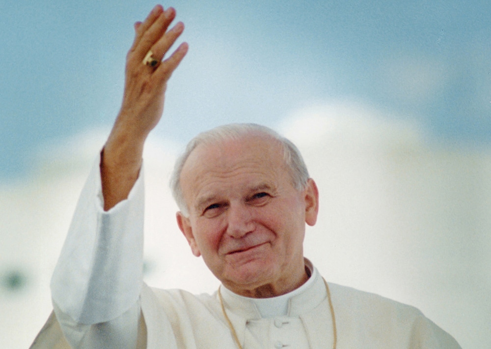 Pope John Paul II waves after arriving in Miami for his 1987 visit to United States