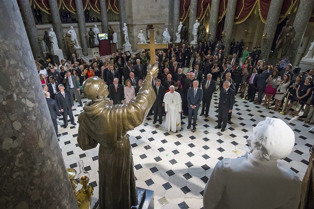 Pope Francis pauses in front of sculpture of St. Junipero Serra at the U.S. Capitol
