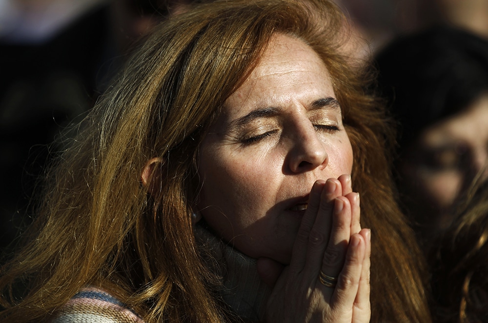 WOMAN PRAYS MASS MADRID