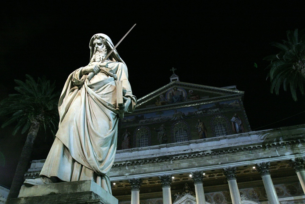 STATUE ILLUMINATED IN NIGHT VIEW OF BASILICA OF ST. PAUL OUTSIDE THE WALLS IN ROME