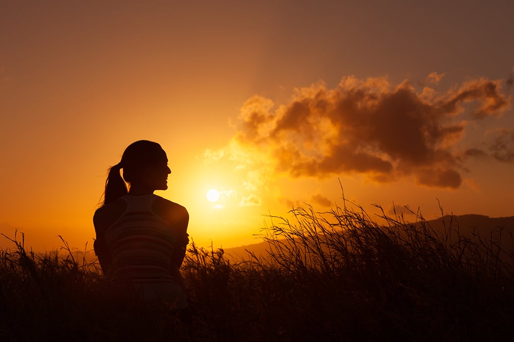 woman looking at sunset