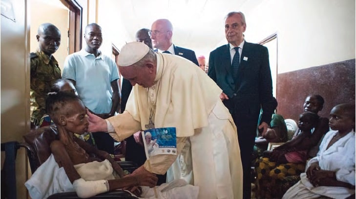 Pope Francis greets patient