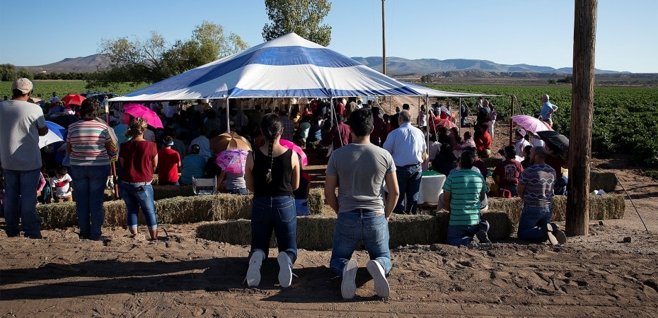 Migrant farmworkers attend an outdoor Mass