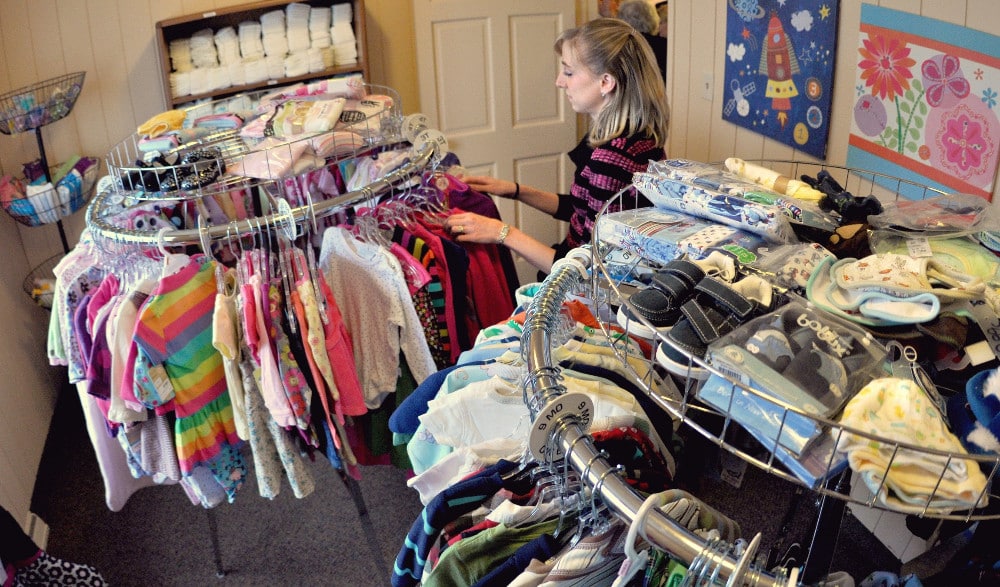 WOMAN ARRANGES CLOTHING AT INDIANA CARE CENTER