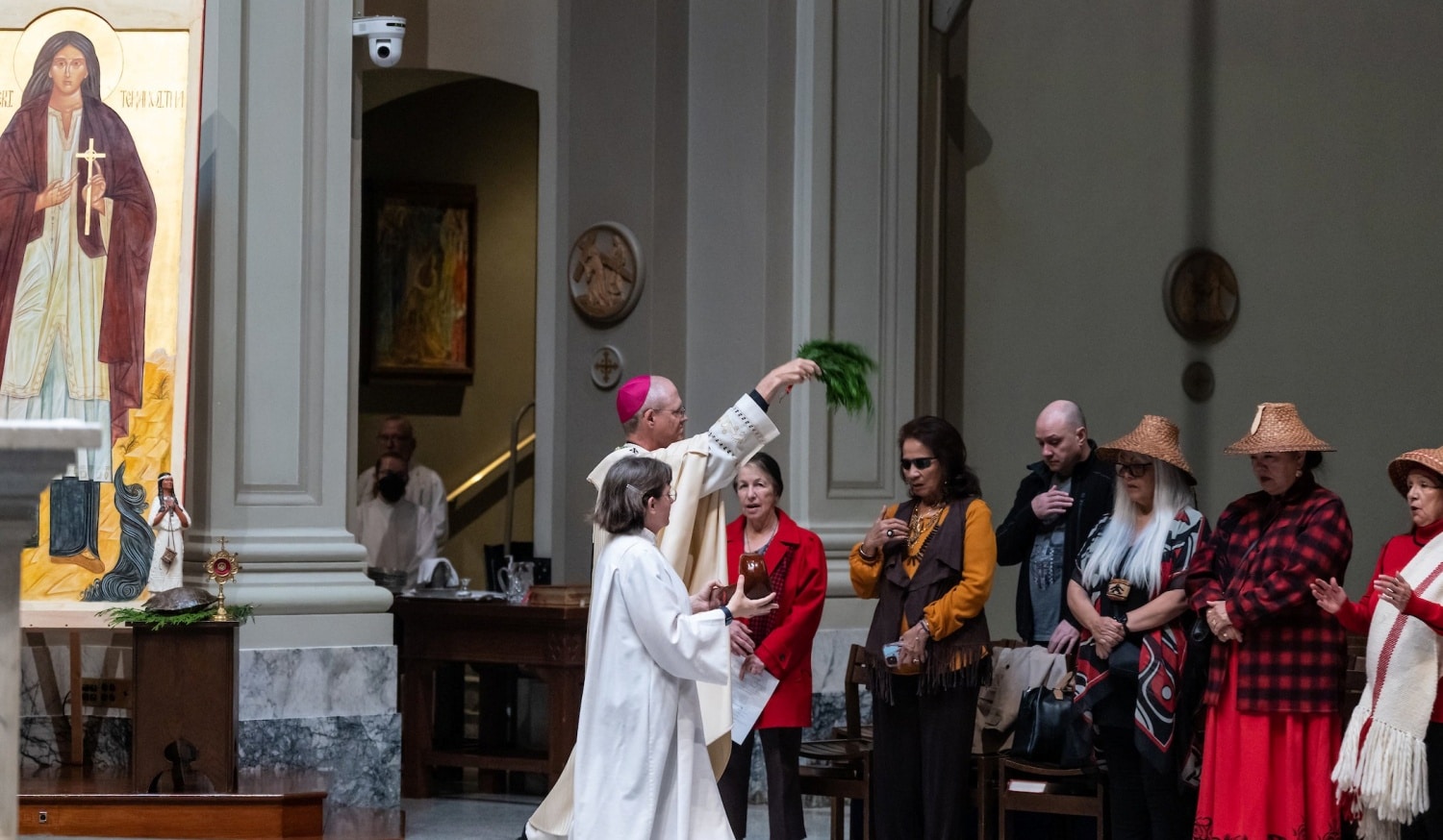 Archbishop Paul D. Etienne of Seattle uses holy water to bless the congregation during Mass at St. James Cathedral in Seattle Oct. 22, 2022. The Mass was in recognition of the 10th Anniversary of the canonization of St. Kateri Tekakwitha. (CNS photo/Stephen Brashear, Northwest Catholic)