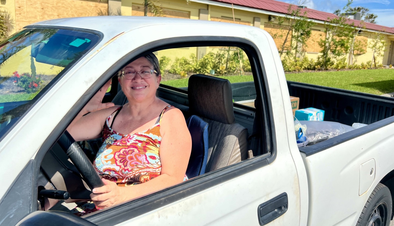 Lizvelle Rivera of Florida is pictured in her car after receiving supplies and food assistance from Catholic Charities Diocese of Venice Oct. 11, 2022. (CNS photo/Katie Camario, Gulf Coast Catholic)