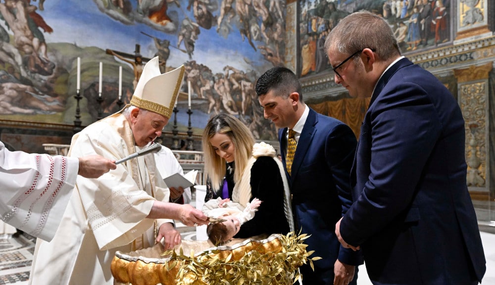 Pope baptizes babies