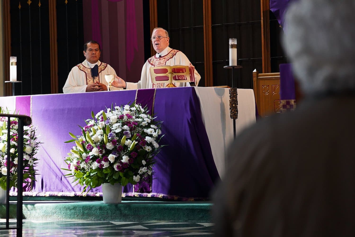 A photo of two priests concelebrating Mass.