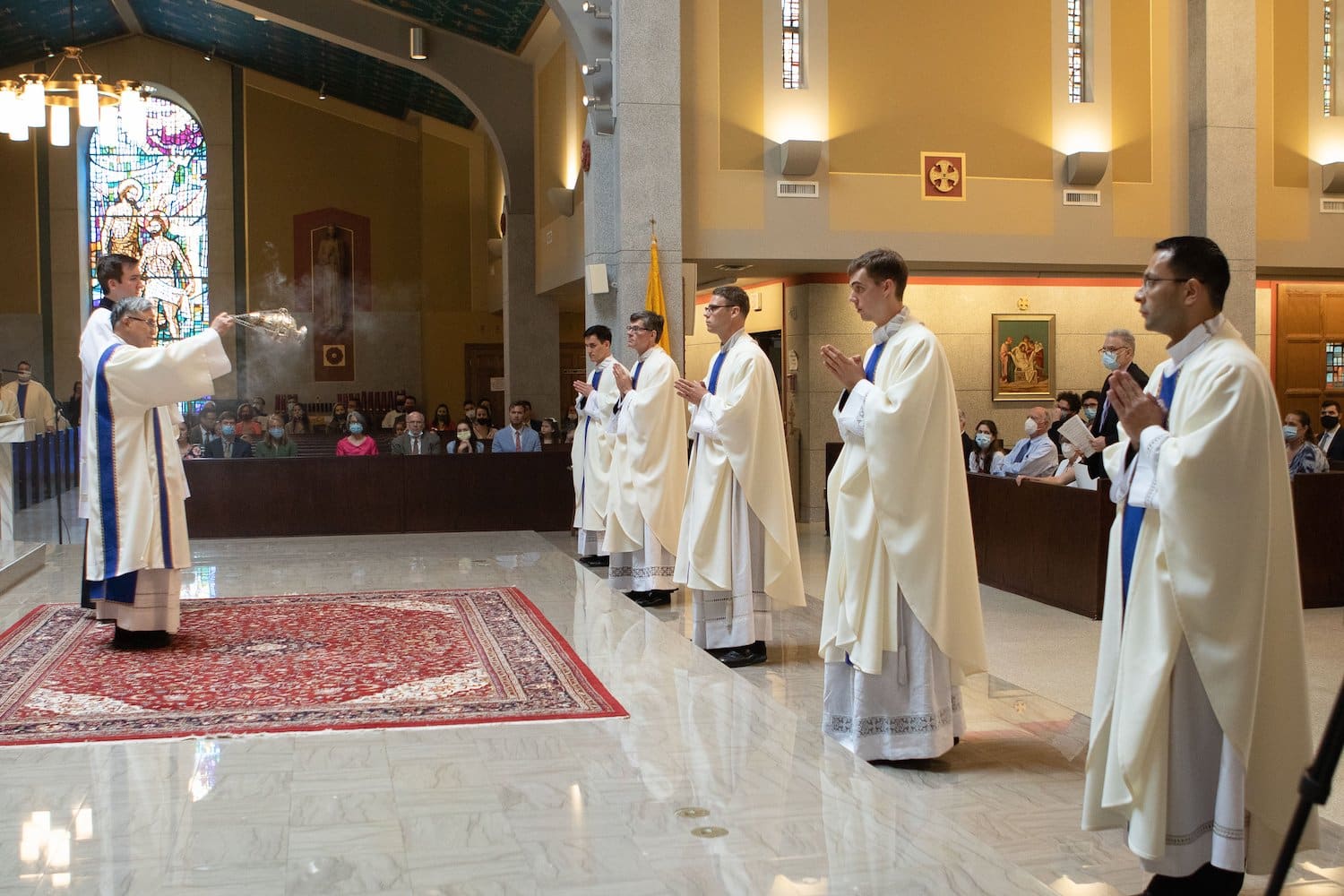 Deacon Vincent Cong Nguyen, assisted by Father Joseph W. Farrell, parochial vicar of St. Timothy Church in Chantilly, Va., uses incense to bless five newly ordained priests at the Cathedral of St. Thomas More in Arlington, Va.