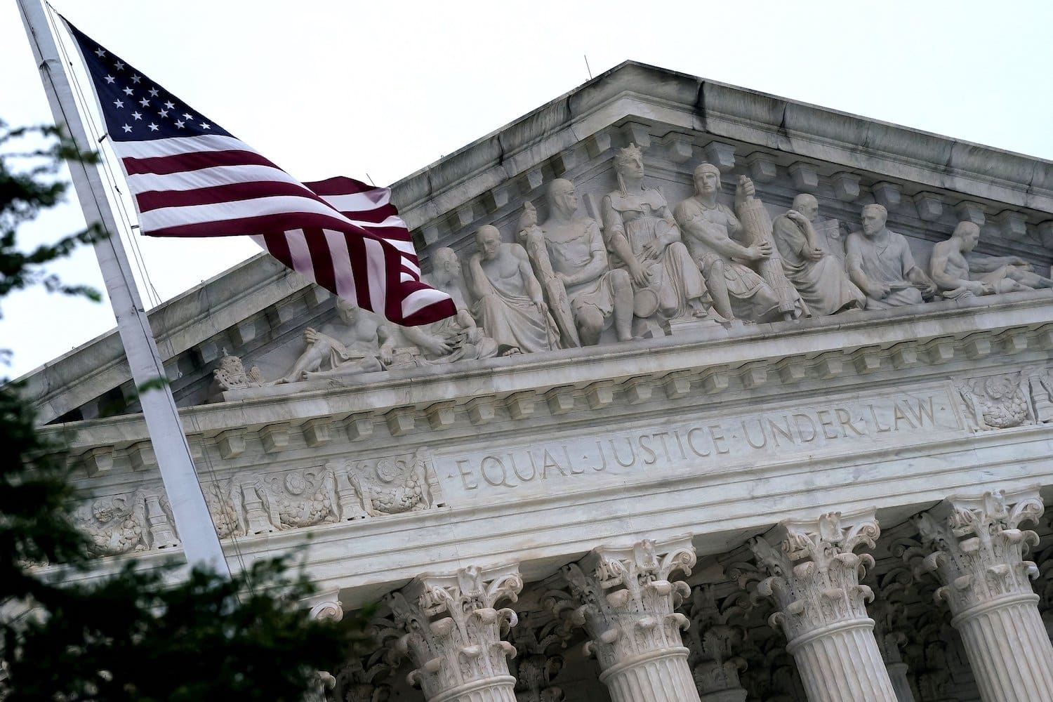The American flag flies in front of the Supreme Court Building.