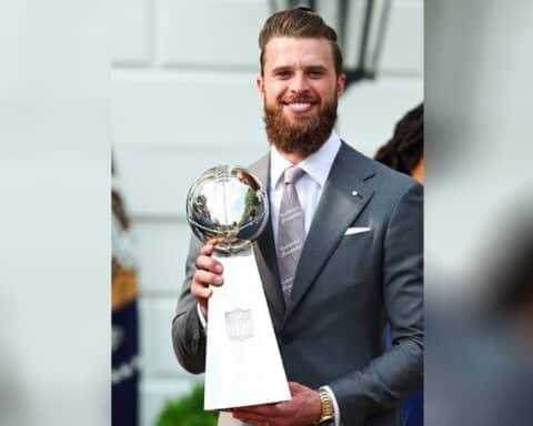 Kansas City Chiefs kicker Harrison Butker, wearing a pro-life tie and tie clip, holds the Super Bowl trophy during a visit to the White House.