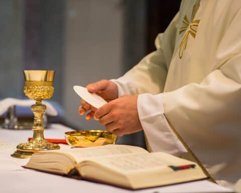 A priest's hands as he prepares Holy Communion