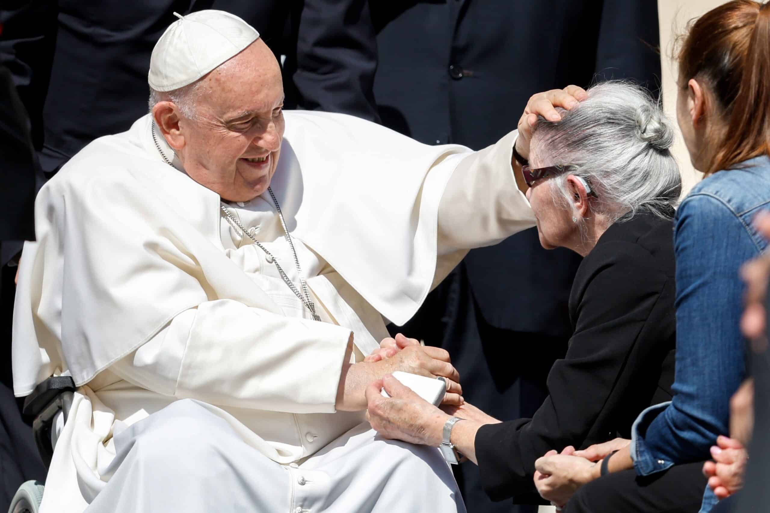Pope Francis greets an elderly woman in the vatican