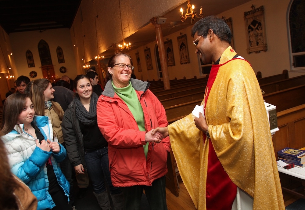 priest greets people