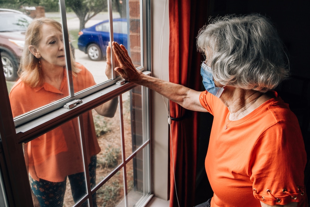 Woman visiting her elderly mother during quarantine