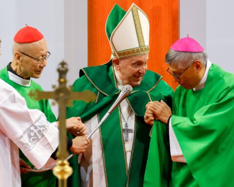 Pope Francis grasps the hands of retired Cardinal John Tong Hon of Hong Kong and Cardinal-designate Stephen Chow Sau-Yan of Hong Kong