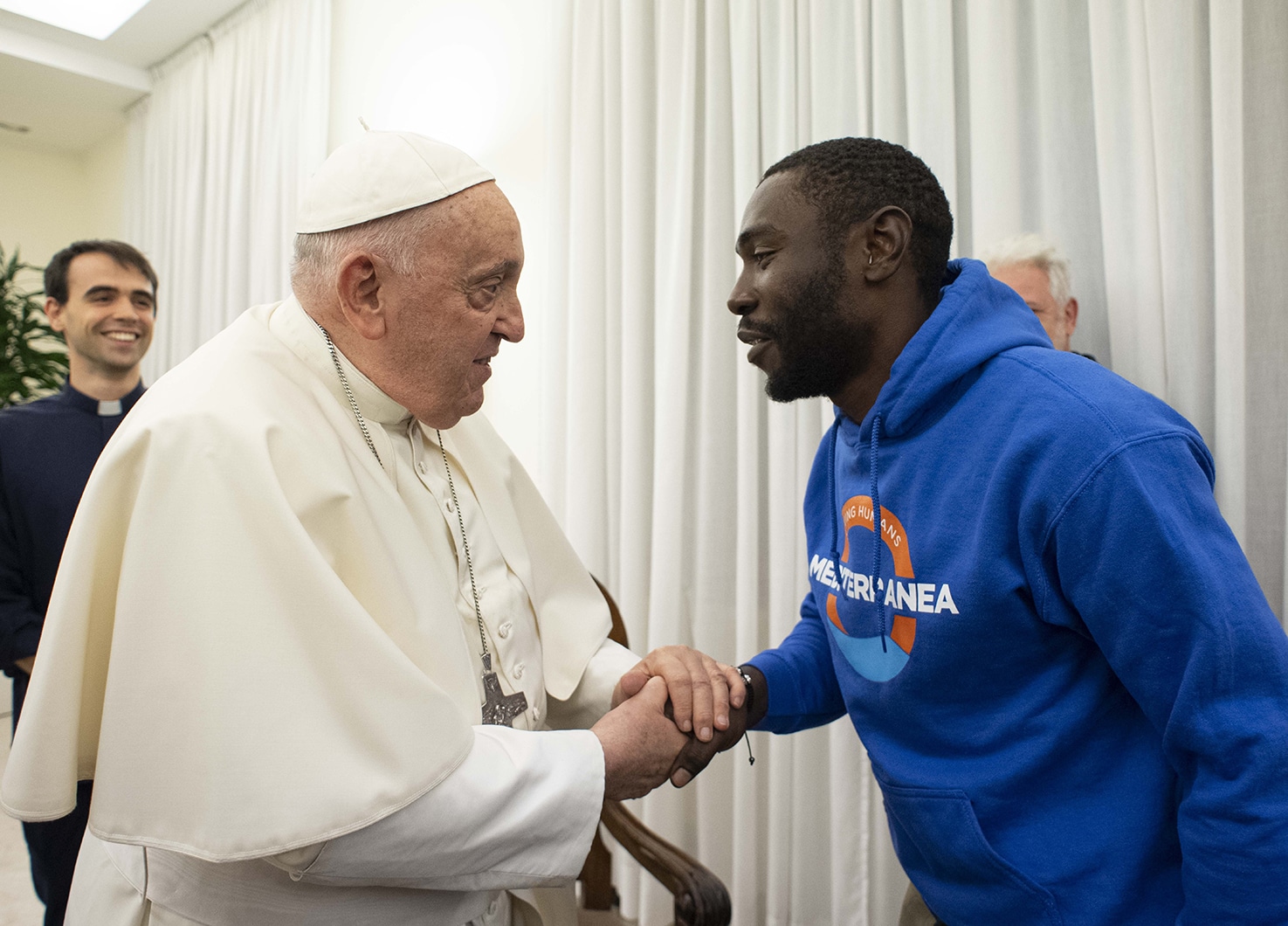 Pope welcomes migrant