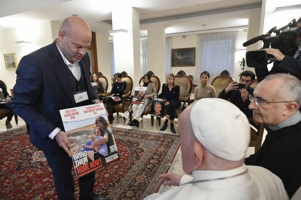 Pope Francis meets relatives of hostages taken by Hamas militants from Israel Oct. 7 in his residence, the Domus Sanctae Marthae, at the Vatican Nov. 22, 2023. Members of the delegation carried posters of their loved ones. (CNS photo/Vatican Media)