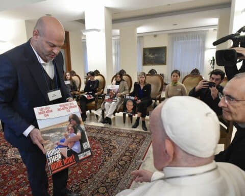 Pope Francis meets relatives of hostages taken by Hamas militants from Israel Oct. 7 in his residence, the Domus Sanctae Marthae, at the Vatican Nov. 22, 2023. Members of the delegation carried posters of their loved ones. (CNS photo/Vatican Media)